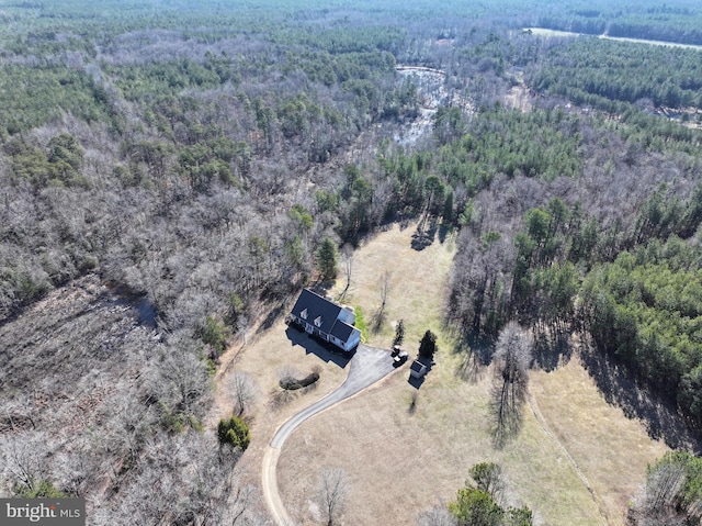 birds eye view of property with a forest view