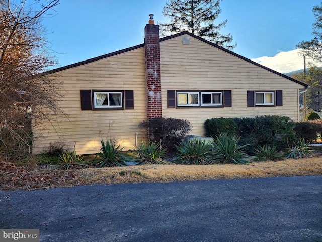 view of property exterior with a chimney