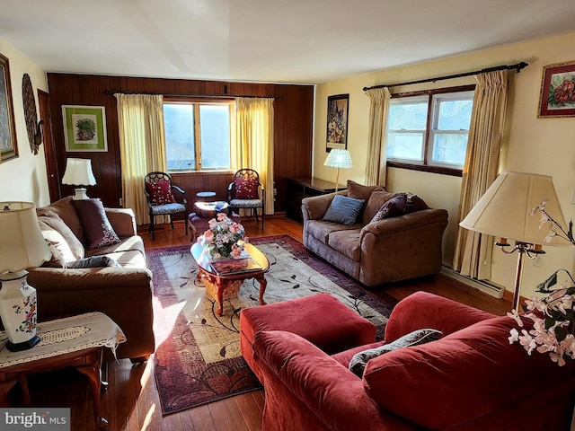 living area with wooden walls and hardwood / wood-style floors