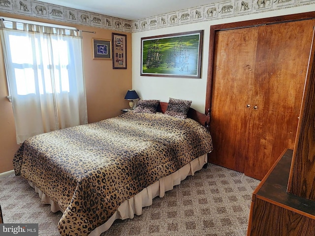 carpeted bedroom featuring a closet