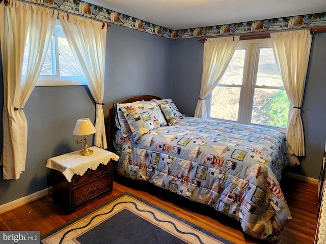 bedroom featuring baseboards and wood finished floors