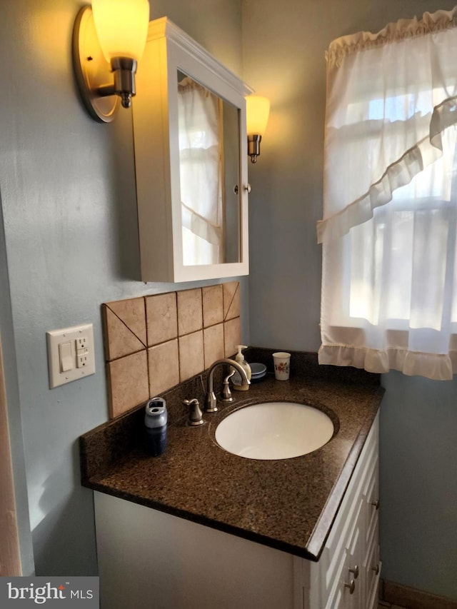 bathroom featuring tasteful backsplash and vanity