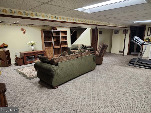 living room featuring a paneled ceiling, carpet flooring, and visible vents