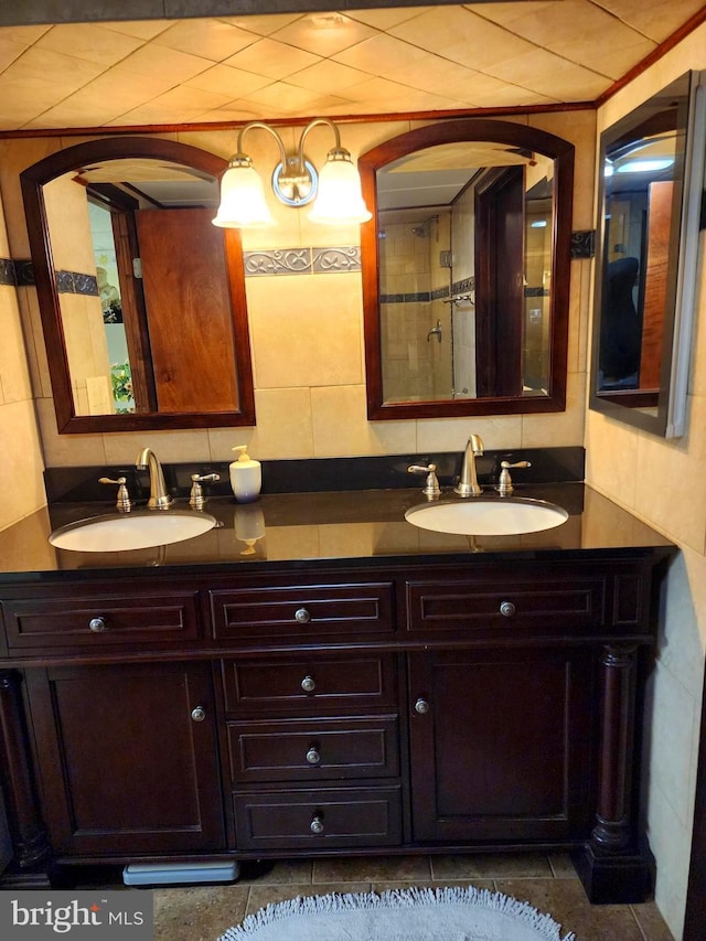 full bathroom with double vanity, tasteful backsplash, and a sink