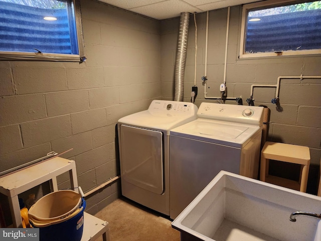 laundry area with a sink and washer and clothes dryer