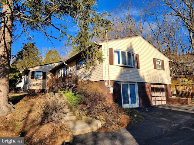 exterior space featuring an attached garage and aphalt driveway