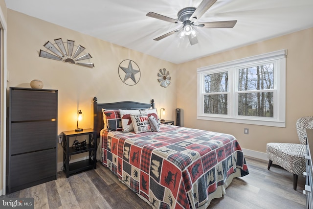 bedroom featuring ceiling fan, wood finished floors, and baseboards