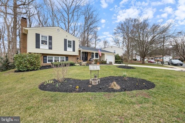 tri-level home featuring a garage, brick siding, a front lawn, and a chimney