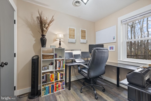 office space with wood finished floors, visible vents, and baseboards