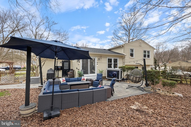 back of house featuring fence, an outdoor living space, and a patio