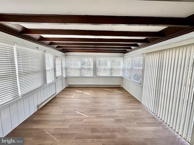 unfurnished sunroom featuring a baseboard heating unit, beamed ceiling, and a baseboard radiator