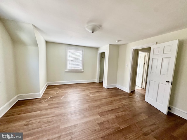 unfurnished bedroom with baseboards and wood finished floors