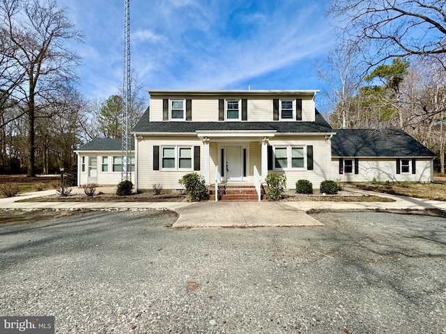 view of front of house with a shingled roof