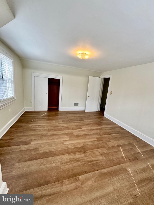 interior space featuring visible vents, baseboards, and wood finished floors