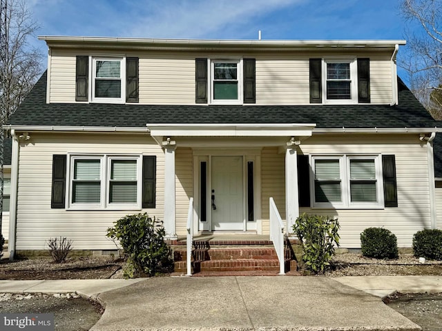 view of front of home featuring covered porch and a shingled roof