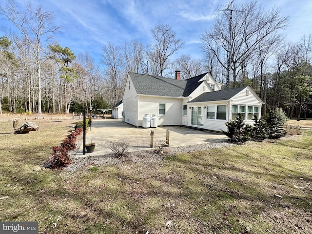 view of side of home with a patio