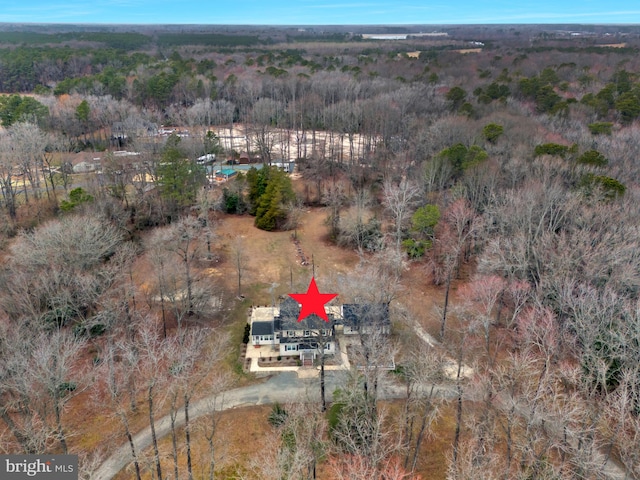 drone / aerial view featuring a wooded view