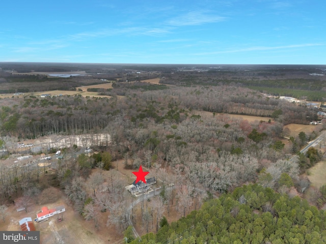 drone / aerial view with a wooded view