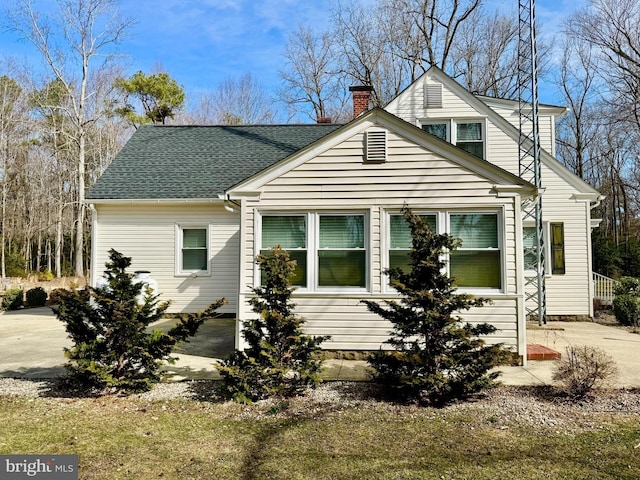 view of front of house featuring roof with shingles