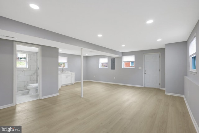 basement featuring light wood-type flooring, visible vents, a wealth of natural light, and recessed lighting