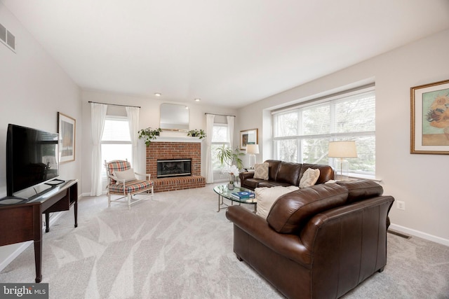 living room featuring a brick fireplace, light colored carpet, and baseboards