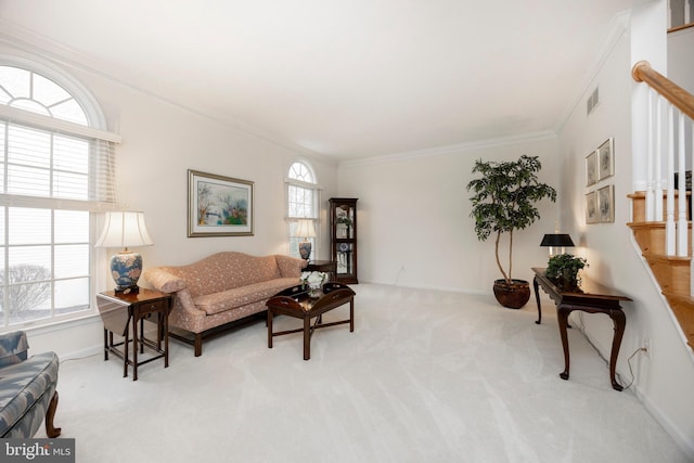 living area featuring visible vents, baseboards, stairway, ornamental molding, and carpet floors