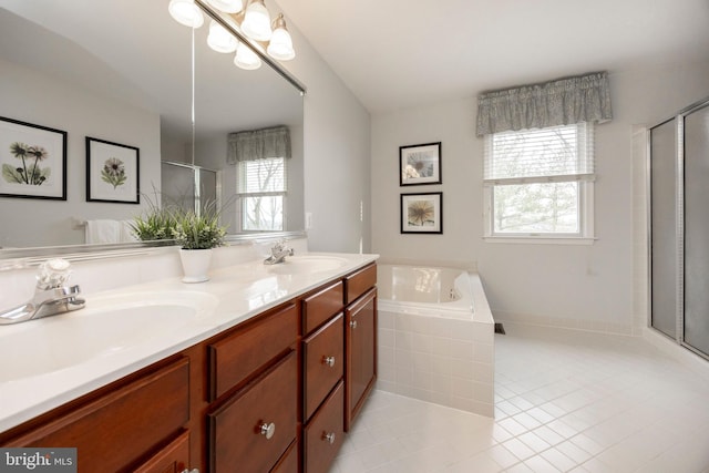 bathroom featuring double vanity, a stall shower, a sink, and tile patterned floors