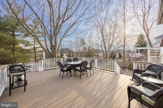 wooden deck featuring outdoor dining area