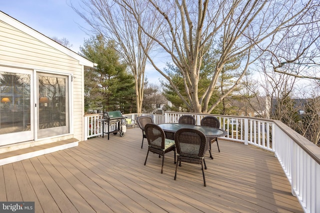 wooden terrace with outdoor dining space