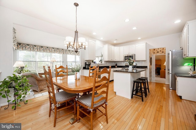 dining room featuring a notable chandelier, recessed lighting, and light wood-style floors