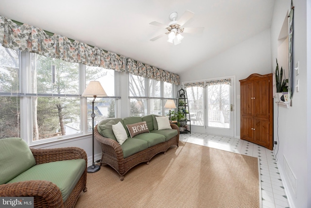 living area featuring vaulted ceiling, light floors, and ceiling fan