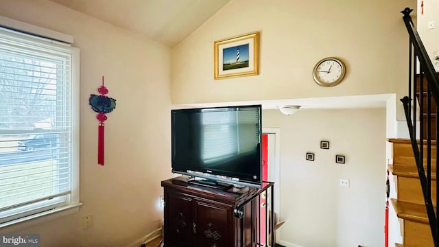 living area with stairs and vaulted ceiling