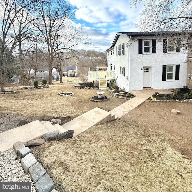 view of property exterior with a fire pit and a deck