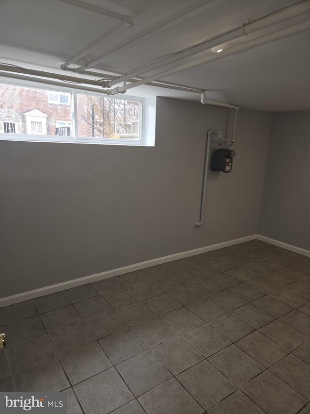 below grade area featuring baseboards and a healthy amount of sunlight