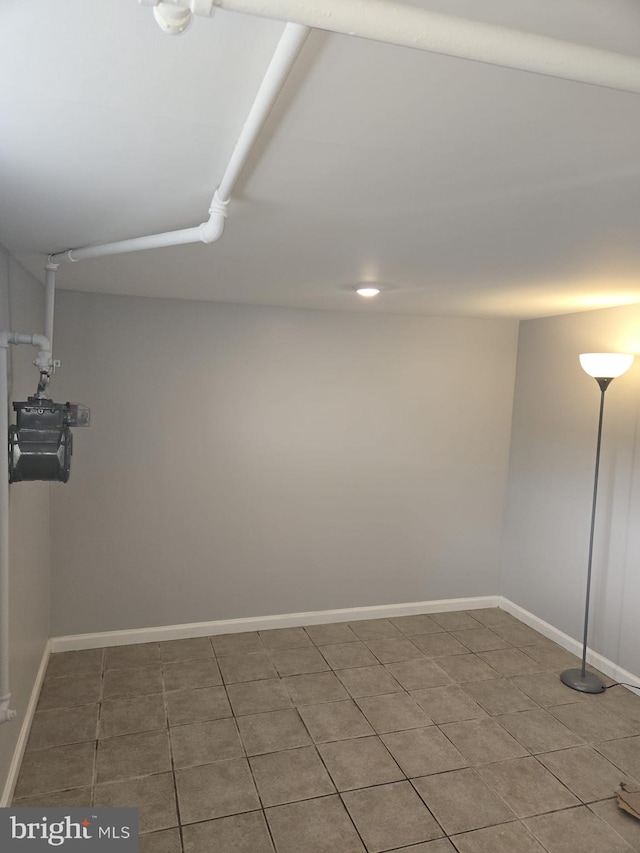 interior space featuring tile patterned flooring and baseboards