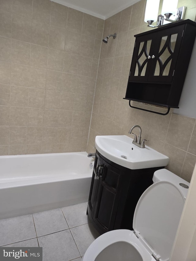 bathroom with crown molding, tile walls, toilet, shower / bathtub combination, and tile patterned flooring