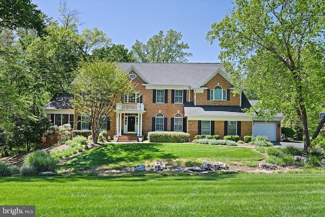 10310 Mystic Meadow Way, Oakton, VA 22124 - colonial inspired home featuring brick siding, a garage, a front yard, a balcony, and driveway