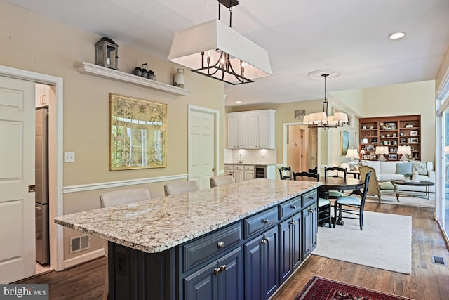 10310 Mystic Meadow Way, Oakton, VA 22124 - kitchen with freestanding refrigerator, dark wood-style floors, white cabinets, a chandelier, and blue cabinets