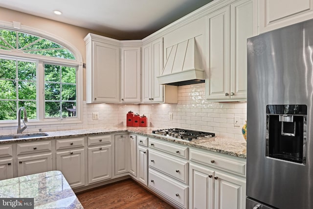 10310 Mystic Meadow Way, Oakton, VA 22124 - kitchen with white cabinets, appliances with stainless steel finishes, a sink, premium range hood, and backsplash