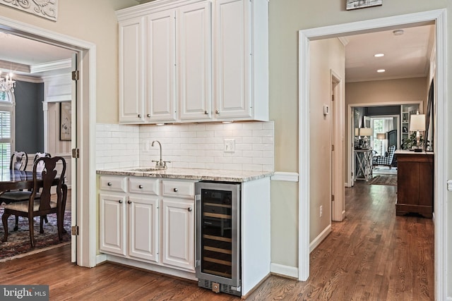 10310 Mystic Meadow Way, Oakton, VA 22124 - bar featuring backsplash, ornamental molding, a sink, and wine cooler