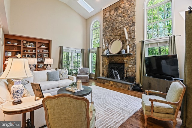 10310 Mystic Meadow Way, Oakton, VA 22124 - living area featuring a skylight, high vaulted ceiling, a fireplace, and wood finished floors