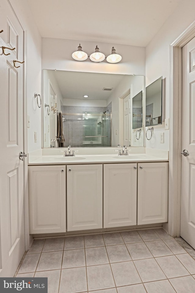 10310 Mystic Meadow Way, Oakton, VA 22124 - bathroom with tile patterned flooring, double vanity, a sink, and a stall shower