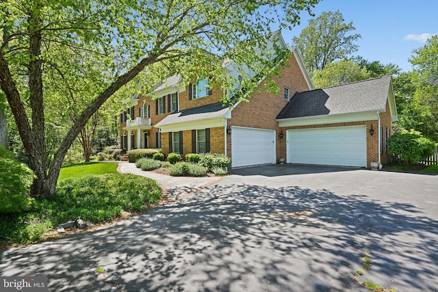 10310 Mystic Meadow Way, Oakton, VA 22124 - view of front facade with a garage, brick siding, and aphalt driveway