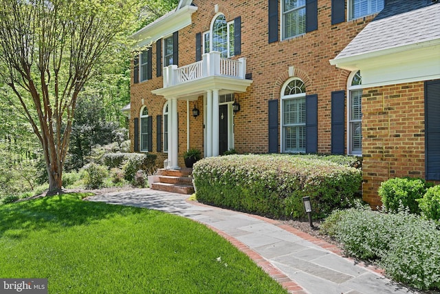 10310 Mystic Meadow Way, Oakton, VA 22124 - doorway to property with brick siding, a lawn, and a balcony