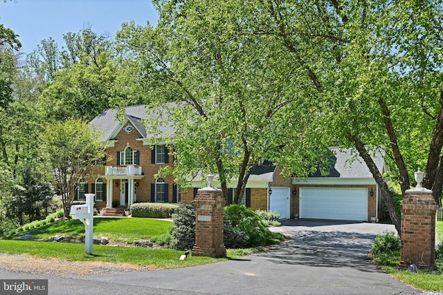 10310 Mystic Meadow Way, Oakton, VA 22124 - view of front of property featuring brick siding, a front yard, and aphalt driveway