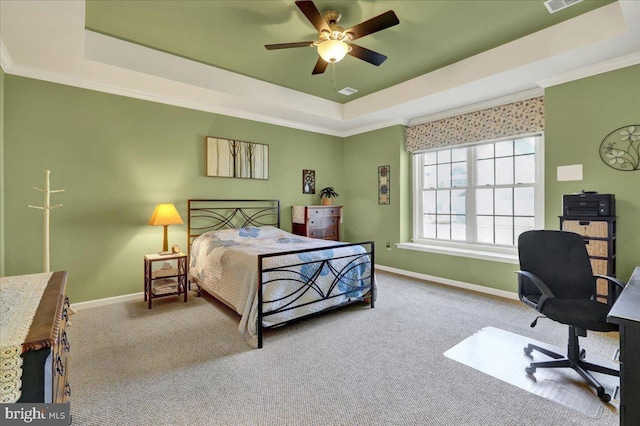 carpeted bedroom featuring a raised ceiling, visible vents, baseboards, and ornamental molding