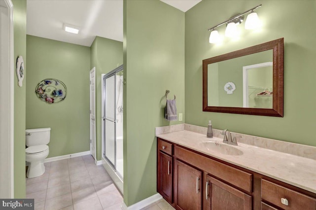 full bath featuring tile patterned flooring, vanity, and a stall shower