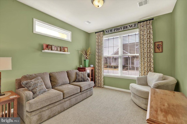 carpeted living room featuring baseboards, visible vents, and a wealth of natural light