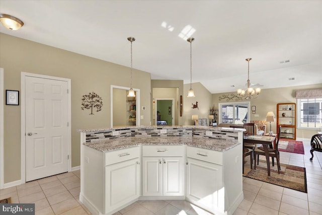 kitchen featuring a wealth of natural light, white cabinetry, hanging light fixtures, and light tile patterned floors