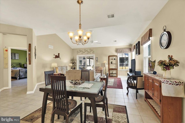 dining space featuring light tile patterned floors, visible vents, an inviting chandelier, and lofted ceiling